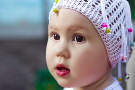 Funny looking girl with big brown eyes. Portrait child close up.の写真素材