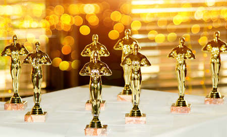 Figurines, award, Oscar. The concept of Victory, games and winnings. Background. Win and Playの写真素材