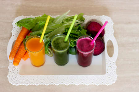 Vegetable smoothies detox - Carrot, beet and green salad. Vegetarian Organic Food. Freshly squeezed juice cocktail. Closeupの写真素材