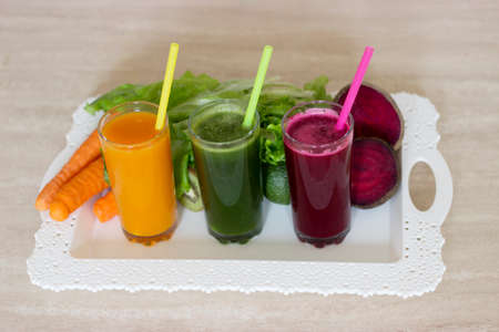 Vegetable smoothies detox - Carrot, beet and green salad. Vegetarian Organic Food. Freshly squeezed juice cocktail. Closeupの写真素材
