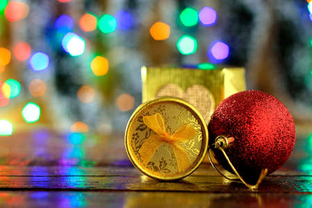 gift boxes on wooden table, christmas decoration, blurred lights on the background