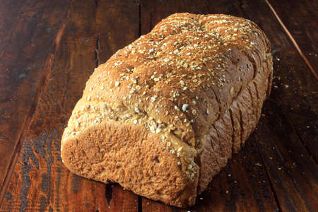 Sliced organic wholemeal bread, made from oats and flax seeds on breakfast table. Healthy diet. Top...