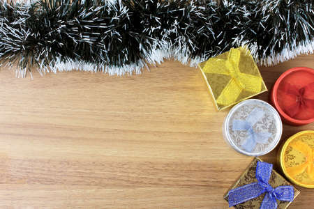 wooden background, christmas decoration with balls and gifts, decorative tree branches, front view