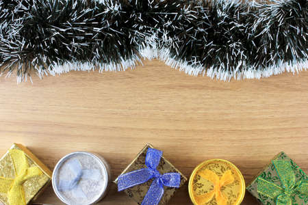 wooden background, christmas decoration with balls and gifts, decorative tree branches, front view
