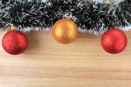 wooden background, christmas decoration with balls and gifts, decorative tree branches, front view