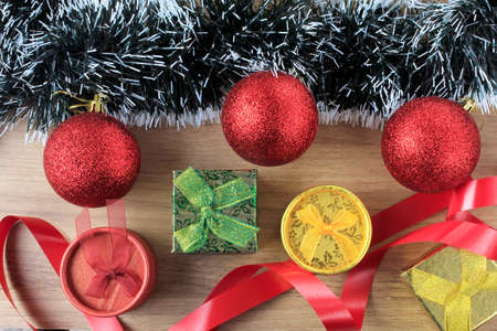 wooden background, christmas decoration with balls and gifts, decorative tree branches, front view