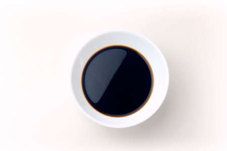 Soy sauce in a ceramic bowl isolated on white background, with clipping path. Copy spaceの写真素材