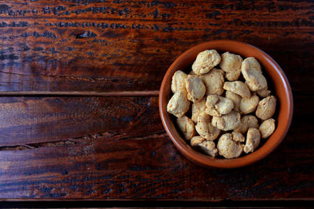 Soybeans meat, chunks in a brown ceramic bowl. Top view of raw soybeans chunks on rustic wooden backgroundの写真素材