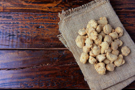 Soybeans meat, chunks on rustic fabric towel. Top view of raw soybeans chunks on rustic wooden...