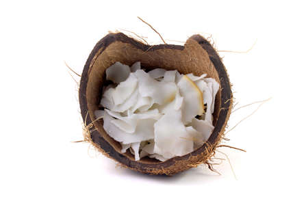 fresh coconut flakes and chips placed in bark isolated on white background. Organic coconut