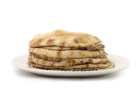 Pita bread isolated on white background in ceramic dish. Traditional and typical food of Arabic...