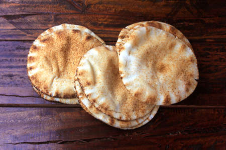Pita bread isolated on rustic wooden table.Traditional and typical food of Arabic cuisineの写真素材