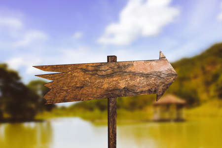 Wooden arrows over blue sky indicating direction. Concept of travelの写真素材