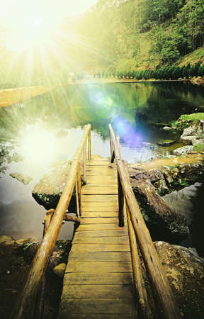 wooden bridge on the shore of a lake in the afternoon. Natural aquatic landscapeの写真素材