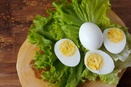 boiled eggs on rustic wooden table. protein-rich food consumed in ketogenic and low carb dietsの写真素材