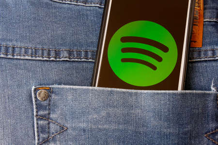 Rio de Janeiro, Brazil - February 14, 2020: Logo Spotify on the Moto G5s Plus smartphone screen, in the jeans pocket. is a music, podcast and video streaming serviceのeditorial素材