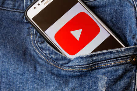 Rio de Janeiro, Brazil - February 14, 2020: Youtube logo on the smartphone screen, in the pocket of jeans. is a video sharing platformのeditorial素材