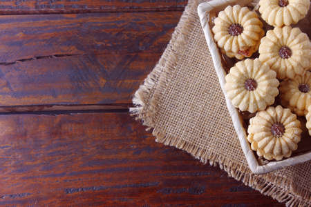 homemade Austrian Linzer cookies are two shortbread cookies, accompanied by a very common jelly at Christmas, on wood rustic tableの写真素材