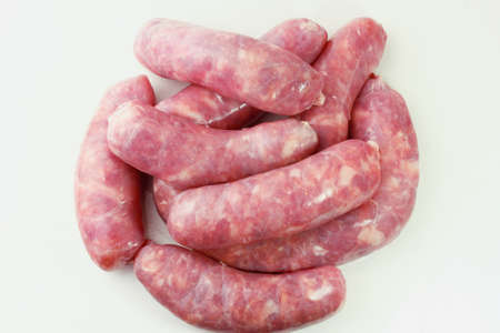 pile of fresh raw pork meat sausage isolated on white background. Top view