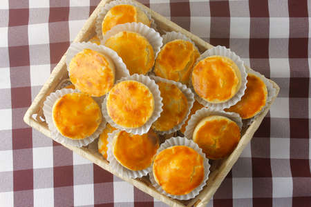 pile of empadas or empadinhas is a very popular and traditional snack of Brazilian cuisine, in a rustic basket on a table lined with a towel. top viewの写真素材