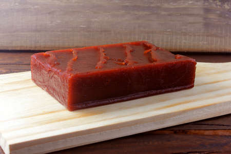 guava candy in bar known in Brazil as Goiabada, isolated on wooden board. Guava sweet dessertの写真素材
