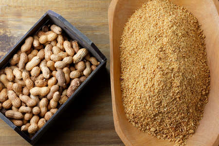 Crushed and ground peanuts in the wooden bowl forming a flour ingredient for the peanut butter and paste and Brazilian paÃ§oca. organic foodの写真素材