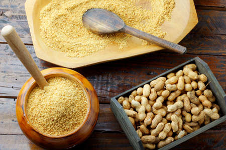 Crushed and ground peanuts in the wooden bowl forming a flour ingredient for the peanut butter and paste and Brazilian paÃ§oca. organic foodの写真素材