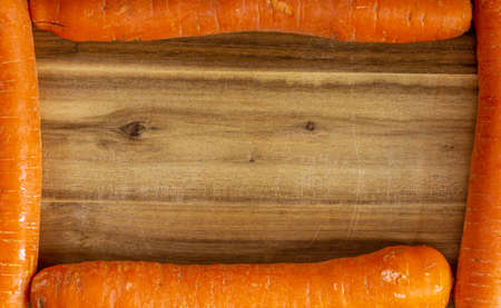 Texture of old wood plank surface with carrot frame backgroundの写真素材