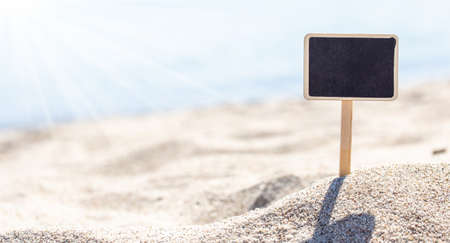 Blank board sign on beach sandの写真素材