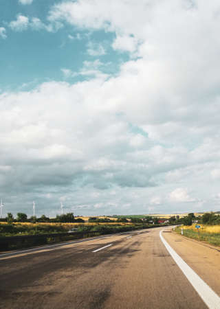 highway road in the countryside with bly sky and cloudsの写真素材