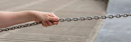 man holding a steel chain - concept of securityの写真素材