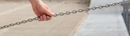 man holding a steel chain - concept of securityの写真素材