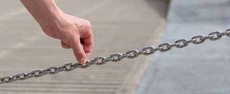 man holding a steel chain - concept of security