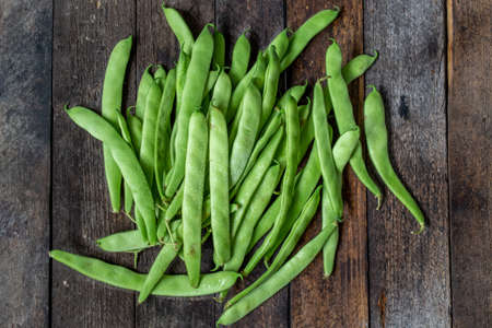 green runner beans on wooden backgroundの写真素材