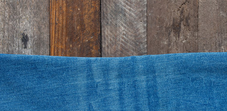 blue jeans on wooden surface backgroundの写真素材