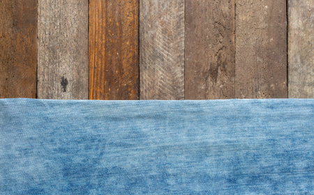 blue jeans on wooden surface backgroundの写真素材