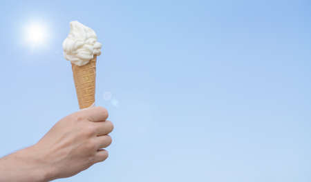soft ice cream cone on blue skyの写真素材