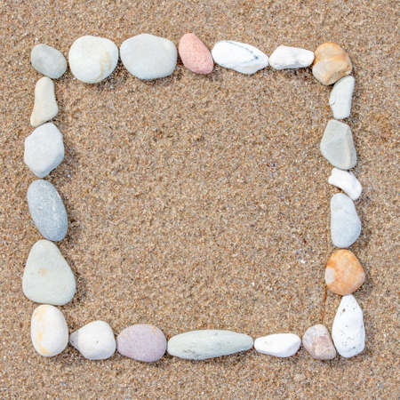 frame made of stones on sand backgroundの写真素材