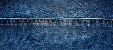 texture of blue jeans denim fabric backgroundの写真素材