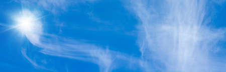 blue sky with white clouds and sun light. Nature background of sky