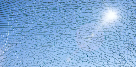 background of broken glass with blue sky in backgroundの写真素材