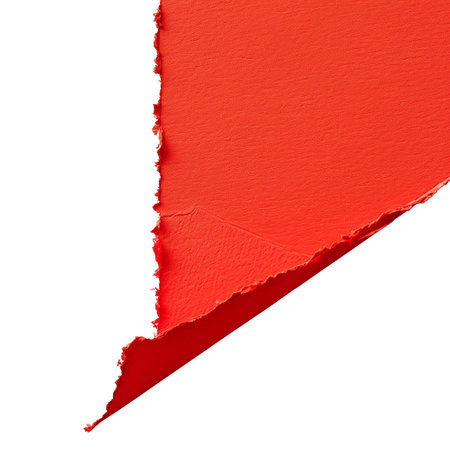 close up of a ripped piece of red paper on white backgroundの素材