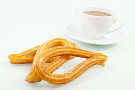 Typical spanish churros with a cup of coffee  Churros is a sweet fried pastry for breakfast の写真素材
