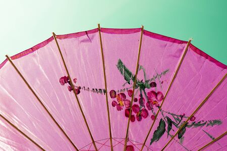 Directly below shot of an ornated pink umbrellaの写真素材