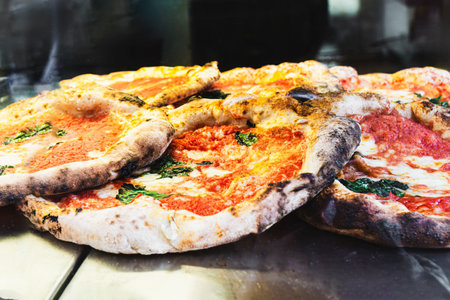 Delicious Neapolitan pizzas with tomato, mozzarella and basil in Naples, Italy