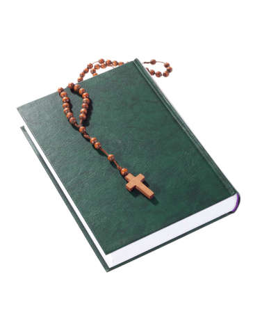 wooden rosary on the Bible, isolated on whiteの写真素材