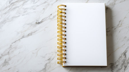 Blank notepad mockup on marble background. Spiral notebook stationery for graphic design, template, mock up. White page surface for presentation and clean workspace. Notepad for new ideas, goals,の素材