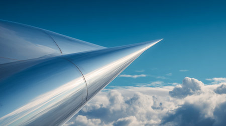 This shot captures a stunning close-up of an airplane wing soaring above a sea of fluffy clouds against a backdrop of clear blue sky. Aviation travel is freedom. Enjoy the journey, the altitude andの素材