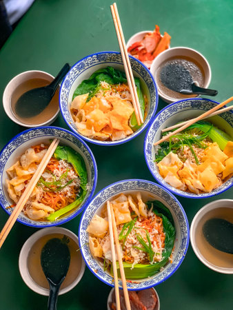 Bowls of chinese noodle soup with chopsticks.の写真素材