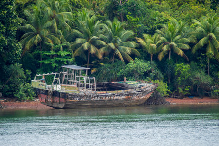 An old wooden ship that is damaged and abandoned on the beachの写真素材
